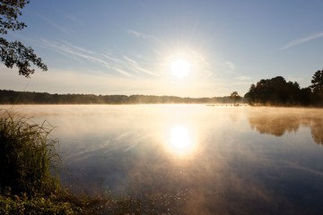 Lake during foggy sunrise