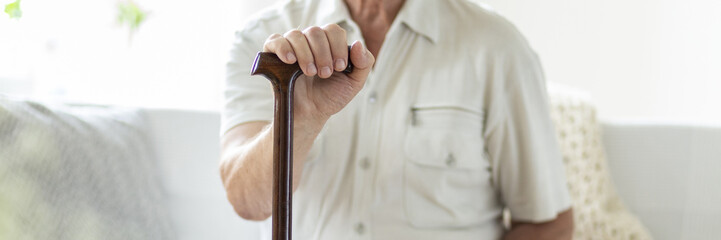Panorama and close-up of senior person with walking stick