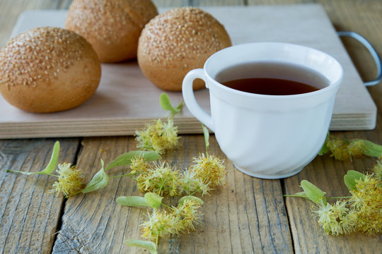 cup of tea with linden flowers on a rustic table