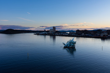 Exterior night view of the city and the glass structure art in the middle of the bay, located in Oslo, Norway