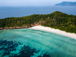 Fototapeta premium Aerial drone view of a long sandy beach on a beautiful tropical island in the Mergui Archipelago, Myanmar