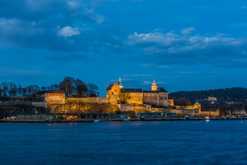 Akershus Fortress at the blue hour. View from the Aker Brygge Marina. Oslo, Norway.