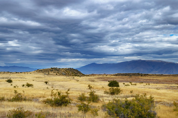Dark gloomy skies over desert field