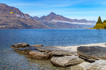 Fototapeta na wymiar Stone pier in lake with mountains in the background 