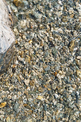 Seabed with smoth stones and water reflections