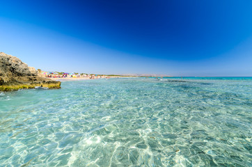 Obraz premium Beautiful crystal clear water at Cittadella dei Maccari, San Lorenzo, Nature Reserve Oasis of Vendicari, Syracuse, Sicily, Italy, Dreamy and idyllic spring holiday destination near Noto and Marzamemi.