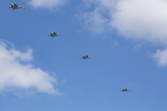 Beautiful picture of several military aircraft flying in blue sky.
