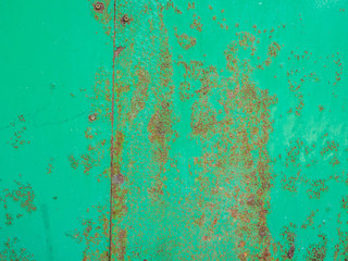 Green metal plate with rust.