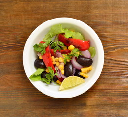 Fried salad with black beans, corn, sweet pepper and red onion, top view