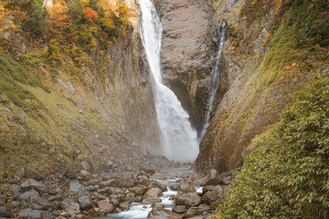 Fototapeta na wymiar Japanese waterfall, Autumn Shomyo Falls in Toyama. 日本の滝　秋の称名滝　富山県立山町