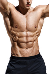 Fototapeta premium Close up of man showing muscular body and six pack abs. Photo of man shirtless on white background. Strength and motivation