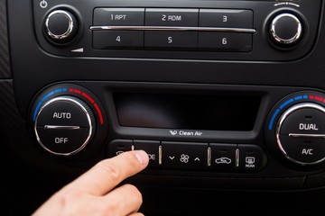 Closeup of a Hand Pressing a Button of a Car Audio System