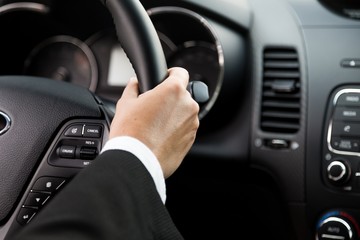 Close-up of a Hand on a Steering Wheel