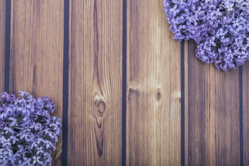 bright lilac flowers on a beautiful wooden background with copy space.