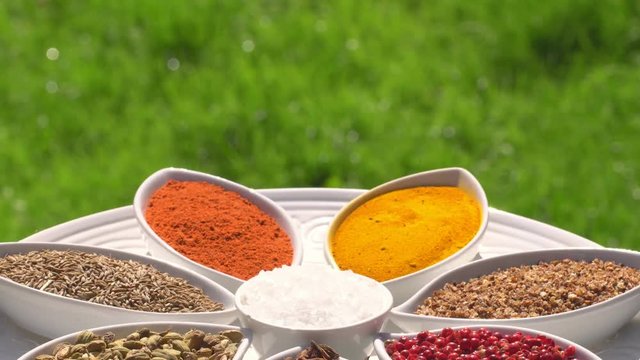 Dry spices on a rotary table. 4K. Macroshooting.