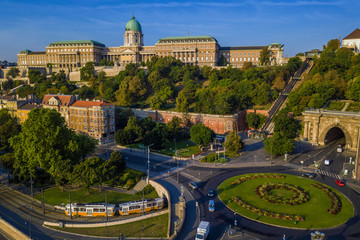 Budapest, Hungary - Clark Adam square roundabout from above at sunrise with Buda Castle Royal Palace and Tunnel and traditional yellow tram - obrazy, fototapety, plakaty