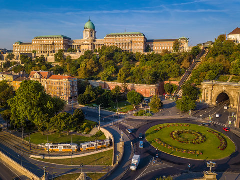 Budapest, Hungary - Clark Adam square roundabout from above at sunrise with Buda Castle Royal Palace and Tunnel and traditional yellow tram