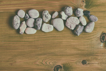 Image of sea stones on wooden table.