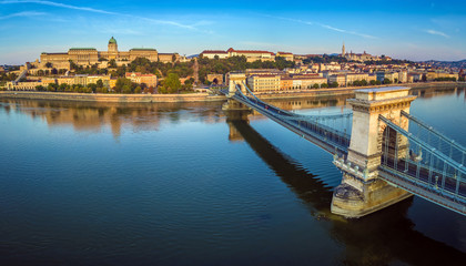 Fototapeta premium Budapest, Hungary - Panoramic aerial view of Szechenyi Chain Bridge at sunrise with Buda Castle Royal Palace, Buda Tunnel, Sandor Palace and Fisherman's Bastion at background
