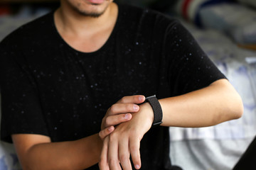 Man looking at his watch on his hand, watching the time using for concept Be Late For Something Day.