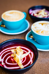 Beetroot Vegan Cold Soup and Cappuccino in Big Blue Cups in Modern Vegan Cafe