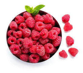 Bowl with ripe raspberries on white background