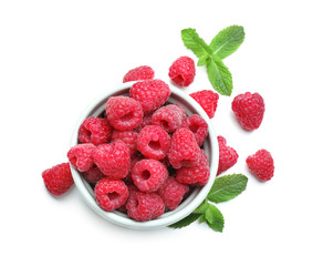 Bowl with ripe raspberries on white background
