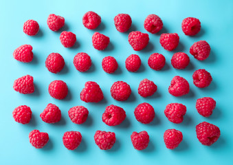 Fresh ripe raspberries on color background, flat lay