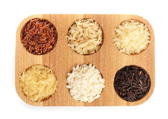 Wooden holder with different types of rice on white background
