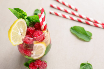 Glass of fresh raspberry mojito on light table