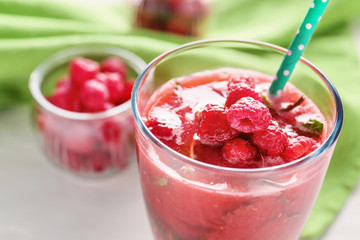 Glass of tasty raspberry smoothie, closeup