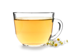 Glass cup of camomile tea on white background