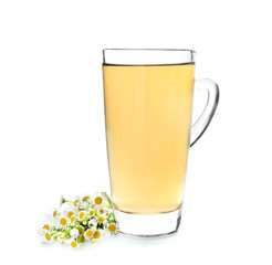 Glass cup of camomile tea on white background