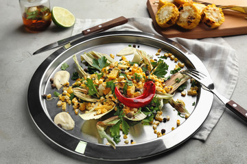 Tasty grilled corns with sauce on metal plate