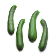 Ripe zucchinis on white background