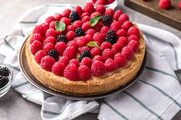 Delicious cheesecake with raspberries on table
