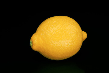 Sour lemon isolated on black background