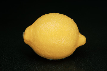 Sour lemon isolated on black background