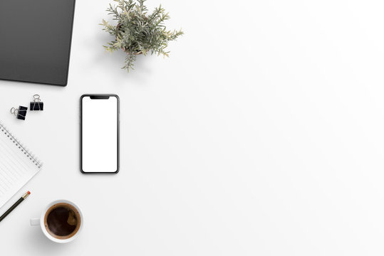 Mobile phone with isolated screen for mockup on white desk with free space for text. Folder, clips, notepad, pencil, cup of coffee and plan beside. Flat lay, top view.