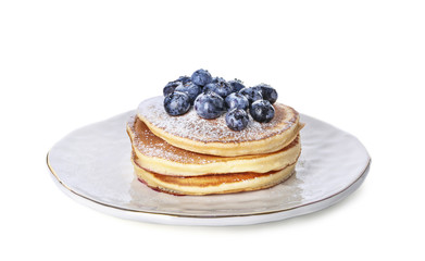 Plate with tasty pancakes and blueberries on white background