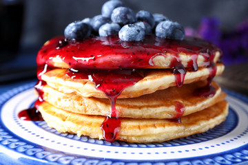 Plate with tasty pancakes, jam and blueberries, closeup