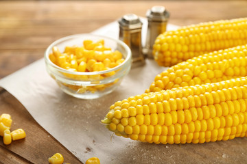 Tasty corn cobs on table, closeup