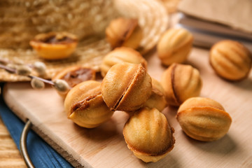 Board with delicious cookies on table, closeup