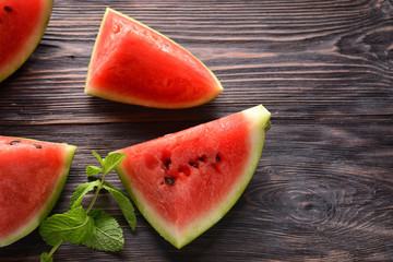 Sweet watermelon slices on wooden background
