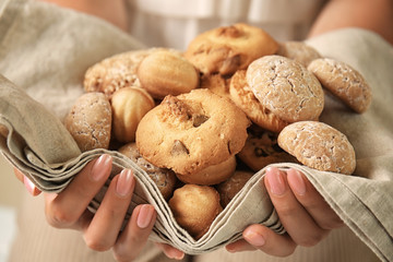 Woman holding delicious cookies, closeup