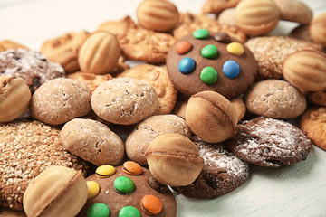 Different delicious cookies on white wooden table, closeup
