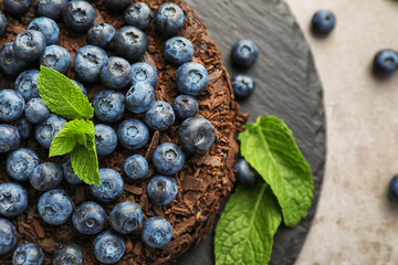 Delicious blueberry chocolate cake on slate plate