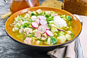 Okroshka in bowl with napkin on board