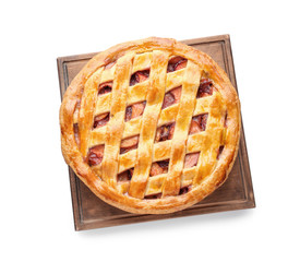 Board with delicious peach pie on white background