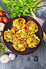 Pepper stuffed with mushrooms and couscous in pan on board top